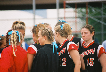 Team huddle after an inning at the 2003 NAIA Softball World Series in Decatur, Ala. versus the University of Mary. - Photo by Steven Aldridge