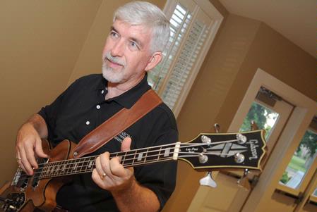 Bill Nettles, physics department chair, plays the guitar with a faculty band before the Faculty/Staff Dinner. - Photo by Morris Abernathy