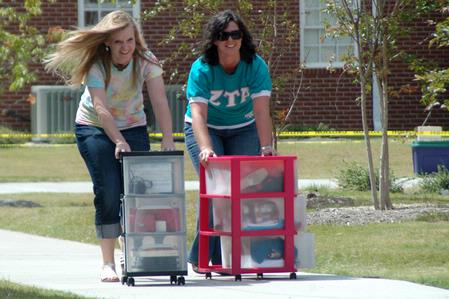 Elissa Weber, sophomore, and Heather Dragg, sophomore, help returning students move into their rooms in The Quads. - Photo by Beth Spain
