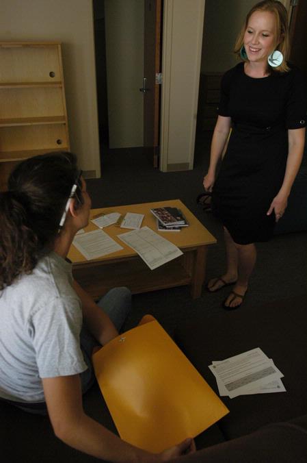 Katherine Pullen, sophomore ICS/Journalism major, speaks with her resident advisor Kelly Reed, senior ESL major, about paperwork she needs to complete while moving into her room in the Quads. - Photo by Sarah Palmer Goff