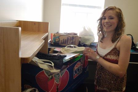 Sophomore Courtney Burton unpacks and organizes her room in the Quads. - Photo by Sarah Palmer Goff