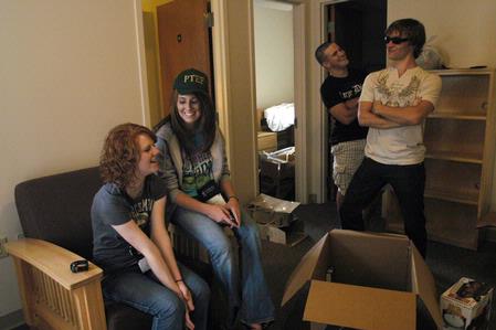 Paul Fickes takes a break from moving into the Quads and poses for friends Leah Thorton, Lauren Layman, and Ryan Gibbons. - Photo by Sarah Palmer Goff