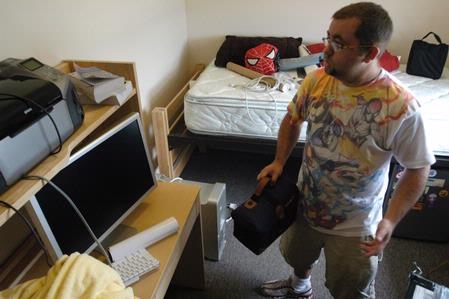 JR Villers, junior DMS major, debates on where to arrange things in his room. - Photo by Sarah Palmer Goff