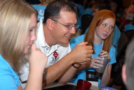 Michael Salazar, associate professor of chemistry, talks with incoming freshmen, such as Lynnsey Park and Stephanie Morris, who are interested in the chemistry department during new student orientation. - Photo by Kristi McMurry Woody