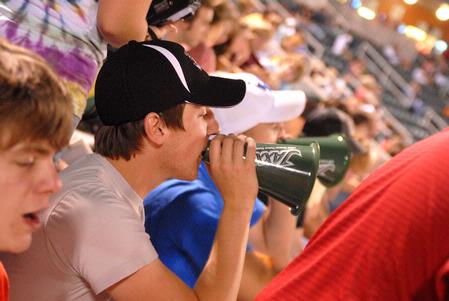 Nathan Fisher, junior English major, yells for the Diamond Jaxx during college night at Pringles Park. Faculty and students from Jackson schools were treated to a $1 game and discounted drinks and food. - Photo by Kristi McMurry Woody