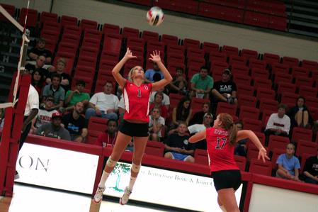 Katie Adams, senior communications major, sets the ball as Anna Sims, sophomore art major, approaches to spike it.  The Lady Bulldogs won this match against Martin Methodist 3-0. - Photo by Kristi McMurry Woody