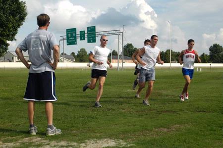 Coach Johnson watches the men's cross country team during practice. - Photo by Sarah Palmer Goff