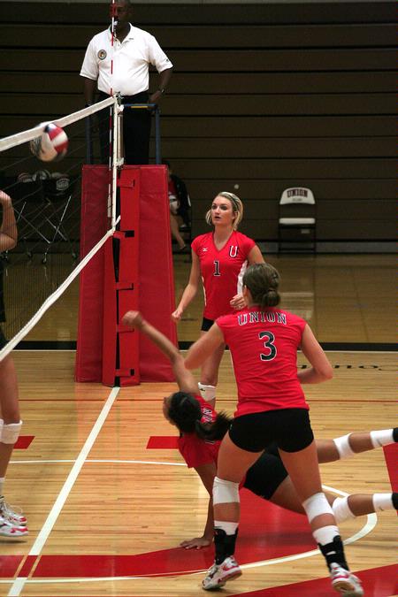 Katie Adams, senior public relations major, and Heather Lieberman, junior business major, watch as their teammate dives to save a ball.  - Photo by Kristi McMurry Woody
