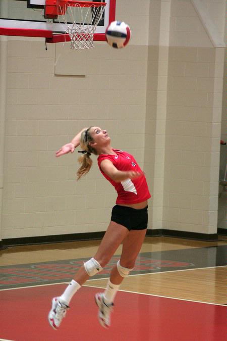 Katie Adams, senior public relations major, serves the ball to Lyon College.   - Photo by Kristi McMurry Woody