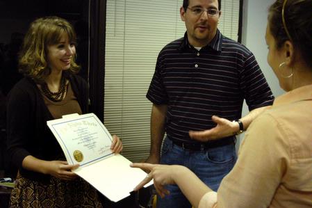 Betsy Davis, junior history/English major, shows off her new Phi Alpha Theta membership to Keith Bates, assistant professor of history, and Elizabeth Blevins, junior history major. - Photo by Sarah Palmer Goff