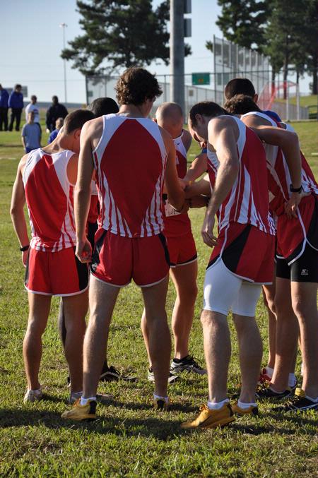 Union men in prayer before the Union Cross Country Invitational. - Photo by Uncredited