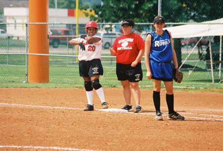 Megan Quarry (20) of Decatur, Ala. and Union graduate assistant coach Jennifer Sabourin communicate at first base during the 2003 NAIA Softball World Series. - Photo by Steven Aldridge