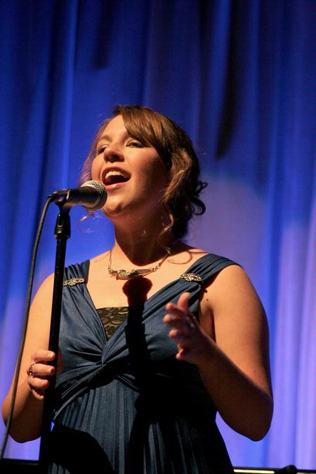Libby Ford, senior accounting major, sings a filler act during All Sing 2009. - Photo by Kristi McMurry Woody