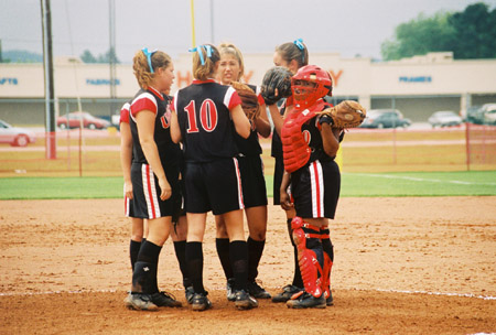 The Lady Bulldog infield talks strategy during a game in the 2003 NAIA Softball World Series in Decatur, Ala. - Photo by Steven Aldridge