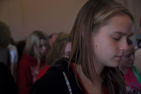 Erin Stephens, freshman TESL major, bows her head for the prayer opening chapel.   - Photo by Megan Bailey