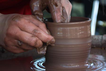 Paige Ward, senior art major, creates pottery during Arts in the Park for Homecoming 2009. - Photo by Megan Bailey