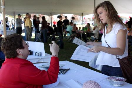 Joanne Stephenson, professor of psychology, speaks with Amy Brown, senior Biblical studies major, about the opportunities in the psychology department during Arts in the Park during Homecoming 2009. - Photo by Megan Bailey