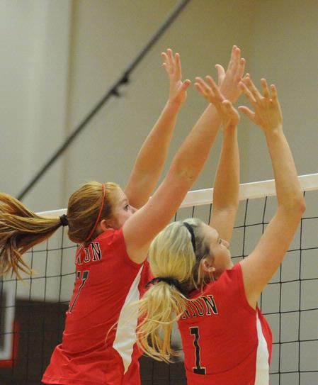 Anna Sims (left) and Katie Adams go up for a block. - Photo by Morris Abernathy