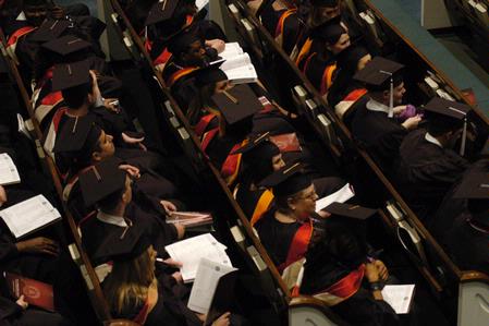 Graduates await to receive their diplomas from President Dockery during fall graduation. - Photo by Sarah Palmer Goff