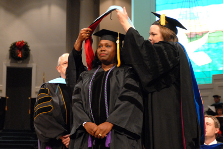 Melinda Harper receives her hood for the doctor of education from Provost Carla Sanderson during fall graduation. - Photo by Kristi McMurry Woody