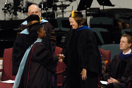 Melinda Harper shakes hands with Provost Carla Sanderson after receiving her doctor of education during fall graduation. - Photo by Sarah Palmer Goff