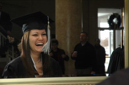 Tara Daniel, family studies graduate, takes a final look in the mirror before fall graduation ceremonies begin at West Jackson Baptist Church. - Photo by Beth Spain