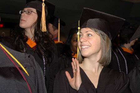 Hannah Brack, social work graduate, waves to family before fall graduation ceremonies begin at West Jackson Baptist Church. - Photo by Beth Spain