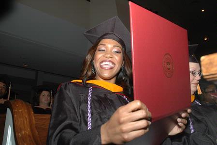 Shawanda Motlow, MSN graduate, shows her diploma during fall graduation. - Photo by Beth Spain