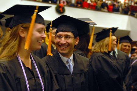 Tara Abernathy and Sam Abraham, nursing graduates, share a laugh as they prepare for fall graduation to begin.  - Photo by Kristi McMurry Woody