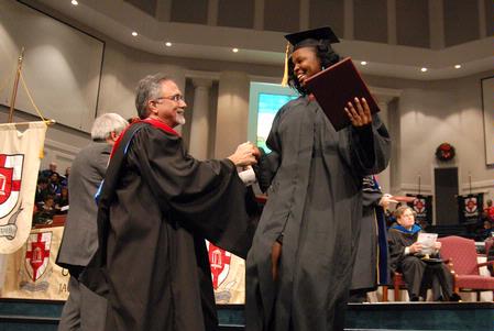 Tarsha Latondra Bond makes her way off the stage after receiving her bachelor of science in nursing at the fall graduation ceremony.  - Photo by Kristi McMurry Woody