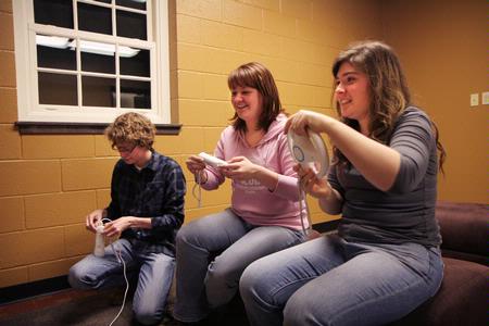 Music majors Drew Gardner, freshman, Shannon Gardner, senior, and Kristin Voorhies, senior, hang out in the new Bowld Commons building. The new facility provides areas for students to study, work out and play games such as Wii. - Photo by Angela Abbamonte
