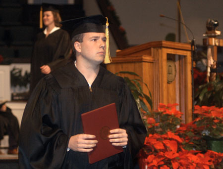 Graduate Jeff Lean looks to the future after receiving his diploma at December graduation.  - Photo by Jim Veneman
