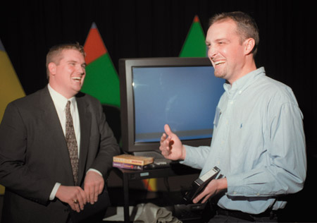 Tim Coleman ('93, right), talks with Broadcasting major Jarod Rogers after Communication Art's "Wisdom from the Trenches" during Homecoming 2002. - Photo by Kasey Carty-Campbell