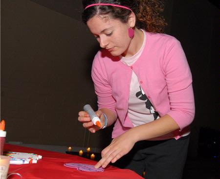 Kayla McKinney, senior learning foundations major, makes a Valentine's Day card for a friend at the Mugs 'N Kisses event hosted by Residence Life. - Photo by Kristi McMurry Woody