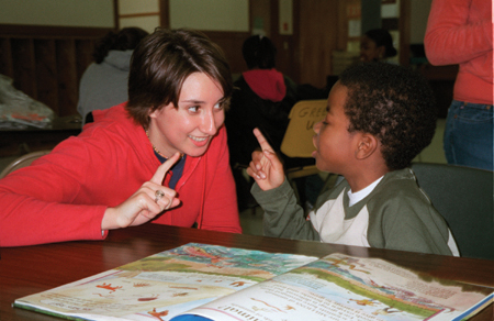 Rebecca Phillips plays with a child at an after-school program while serving on the GO Boston team. - Photo by Uncredited