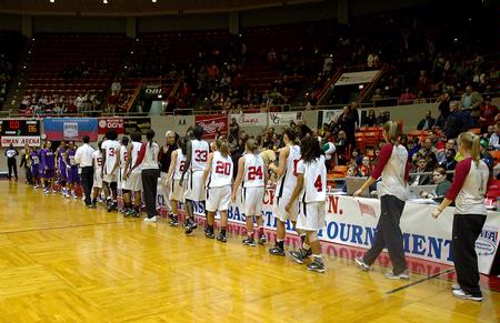 The Lady Bulldogs line up to shake hands with Southwestern Assemblies of God University players after a victory in Game 1 of the NAIA Women's Basketball National Tournament. - Photo by Jordan Buie