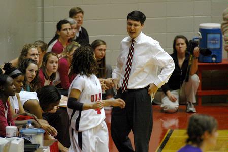Coach Mark Campbell gives Jessica Graves, senior journalism major, a pep talk before she takes to the court in Game 1 of the NAIA Women's Basketball National Tournament against Southwestern Assemblies of God University. The Lady Bulldogs won 86-47. - Photo by Beth Spain