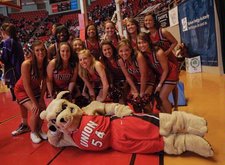 Union's cheerleaders take a break from cheering for the Lady Bulldogs to pose with Buster the Bulldog. The Lady Bulldogs defeated Southwestern Assemblies of God University in Game 1 of the NAIA Women's Basketball National Tournament. - Photo by Morris Abernathy