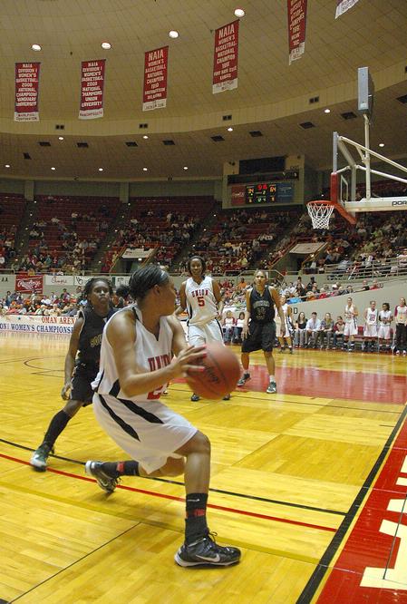 Ashley Lillard, junior psychology major, looks to pass to a teammate in the Second Round game of the NAIA National Tournament against Southern Polytechnic State University. The Lady Bulldogs won 70-47. - Photo by Jordan Buie