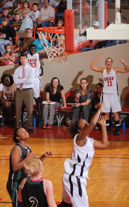 The Lady Bulldogs and coaches cheer from the bench as Union scores in the Second Round game of the NAIA National Tournament against Southern Polytechnic State University. The Lady Bulldogs won 70-47. - Photo by Morris Abernathy