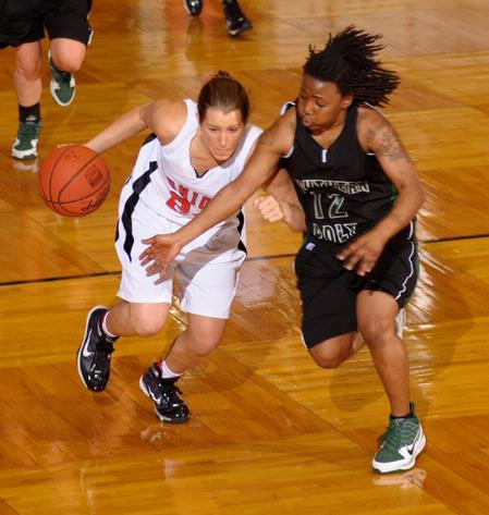 Laura Crittendon, senior athletic training major, dribbles past her Southern Polytechnic State University opponent in the Second Round game of the NAIA National Tournament. The Lady Bulldogs won 70-47. - Photo by Morris Abernathy