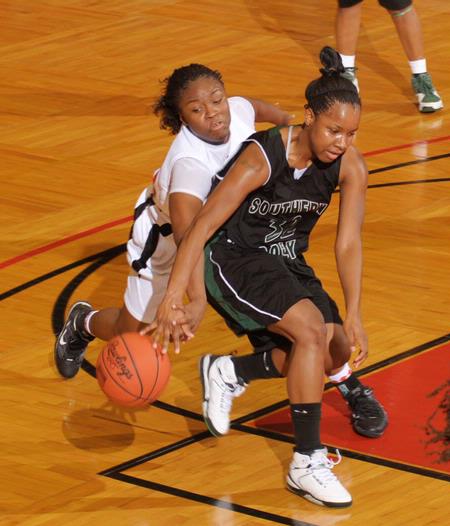 Ashley Lillard, junior psychology major, battles for the ball in the Second Round game of the NAIA National Tournament against Southern Polytechnic State University. The Lady Bulldogs won 70-47. - Photo by Morris Abernathy