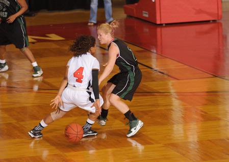 Jessica Graves, senior journalism major, dribbles past her Southern Polytechnic State University opponent in the Second Round game of the NAIA National Tournament. The Lady Bulldogs won 70-47. - Photo by Morris Abernathy