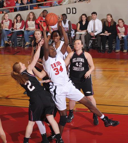 Beatrice Awino Duol, junior learning foundations major, goes up for a rebound in the Quarterfinals game of the NAIA National Tournament against Oklahoma Christian University. The Lady Bulldogs won 83-55. - Photo by Morris Abernathy