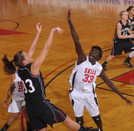 Zeinab Chan, junior history major, jumps to block a shot by Oklahoma Christian University in the Quarterfinals game of the NAIA National Tournament. The Lady Bulldogs won 83-55. - Photo by Morris Abernathy