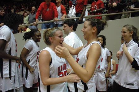 Kayla Hudson, junior political science major, and Kaitlin Dudley, senior physical education and health major, celebrate after their victory over Azusa Pacific University that made them the NAIA Division I National Champions.  - Photo by Jordan Buie