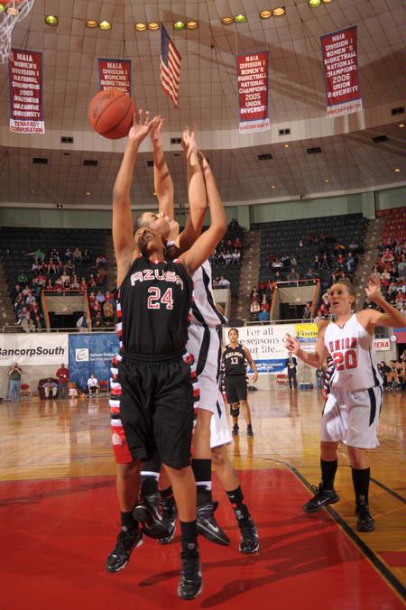 Kaitlin Dudley, senior physical education and health major, goes up for a rebound against her Azusa Pacific University opponent in the Championship game of the NAIA National Tournement. The Lady Bulldogs came out champions with a win of 73-65. - Photo by Morris Abernathy