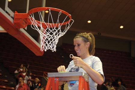 Kayla Hudson, junior, cuts a piece of the net after the Lady Bulldogs defeated Azusa Pacific University to become NAIA Division I National Champions.  - Photo by Morris Abernathy