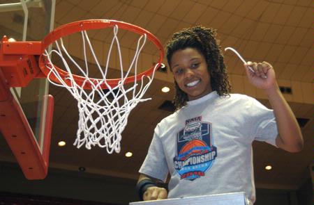 Jessica Graves, senior, cuts a piece of the net after the Lady Bulldogs defeated Azusa Pacific University to win the NAIA National Tournament.  - Photo by Morris Abernathy