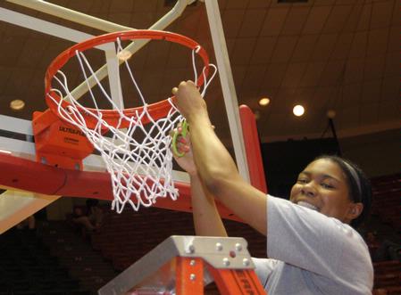 Ashley Lillard, senior, cuts a piece of the net after the Lady Bulldogs defeated Azusa Pacific University to win the NAIA National Tournament.  - Photo by Morris Abernathy